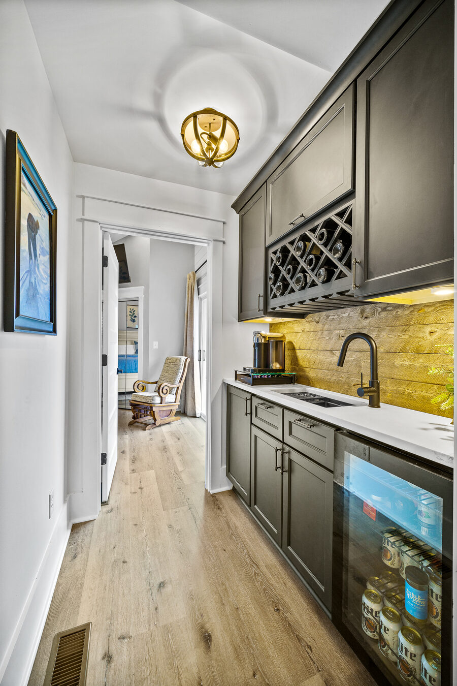 White lakehouse kitchen with double oven and gold hardware