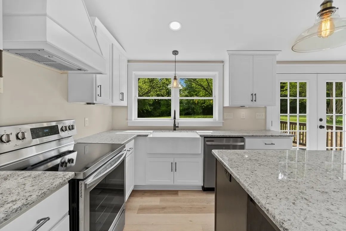 White kitchen with stainless appliances