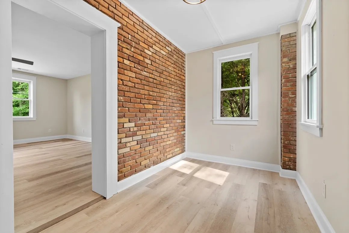 White kitchen with exposed brick