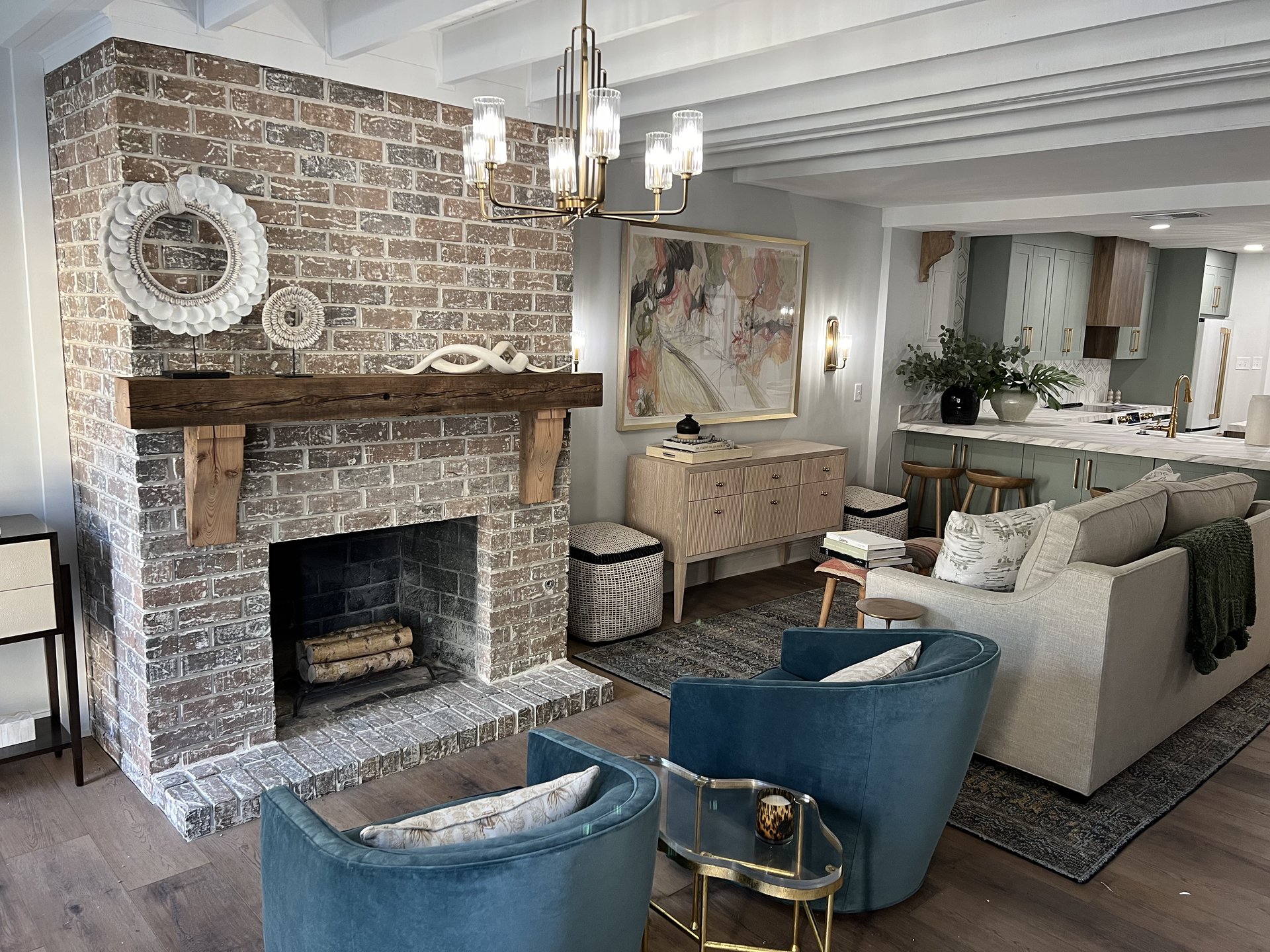 Living room with brick fireplace and kitchen